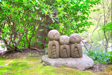 Stone statue of smiling Jizo, Kamakura, Japan