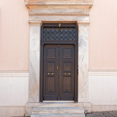 classical house entrance brown wooden door, Athens downtown, Greece
