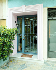 vintage house entrance metalic green door, Athens Greece