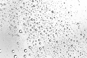 white isolated background water drops on the glass / wet window glass with splashes and drops of water and lime, texture autumn background