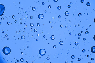 fresh drops background blue glass / wet rainy background, water drops transparent glass blue