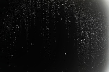Fototapeta na wymiar black wet background / raindrops for overlaying on window, concept of autumn weather, background of drops of water rain on glass transparent