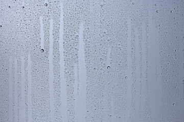 gray wet background / raindrops to overlay on the window, weather, background drops of water rain on the glass transparent