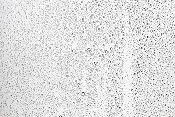 white isolated background water drops on the glass / wet window glass with splashes and drops of water and lime, texture autumn background