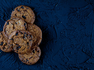 Chocolate chip cookies on a dark stone background