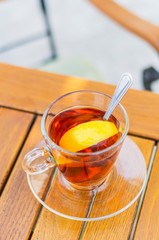 A cup of tea with slice of lemon