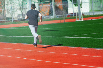 Sport man running on a racetrack