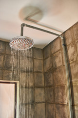 Shower in bathroom with water drops flowing