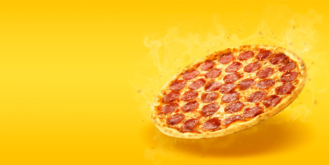 Creative layout of hot delicious pizza with smoke in flying on summer orange background. Pizza...