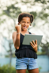 Fototapeta premium Successful teen girl using tablet
