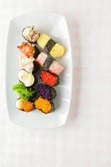 Sushi on white plate, tuna, salmon, sea bass, sweet egg, shrimp sushi, Japanese food.