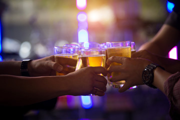 Group of  young people hands toasting and cheering aperitif beers half pint