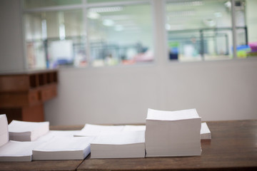 Stack of white papers sheet on office background.
