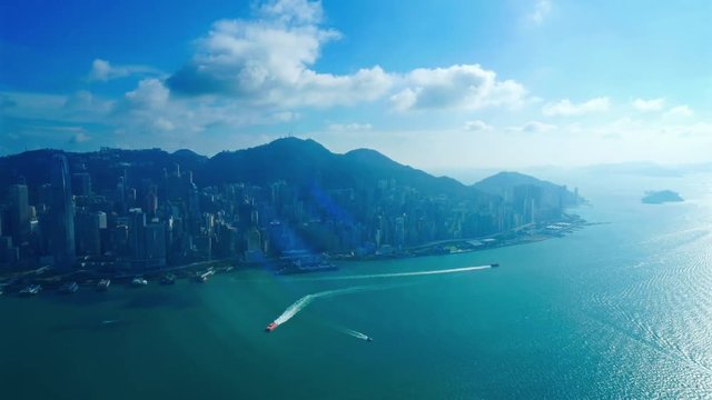 Beautiful Cinematic Hong Kong High Angle Cityscape Timelapse With Towers and Buildings on Coast Boats in Sea Water and Skyline With Clouds