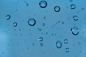 Water drops close up macro shot on blue , abstract image for background.