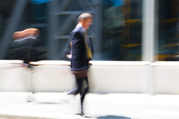 Blur of business people walking in the City of London. UK