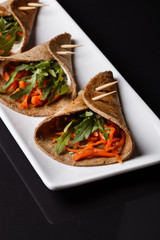 liver pancakes rolls on a dark background