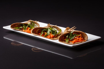 liver pancakes rolls on a dark background