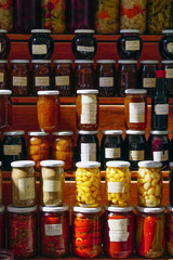 Farmers market in Bursa Turkey selling homemade pickles olive oil herbs close up view