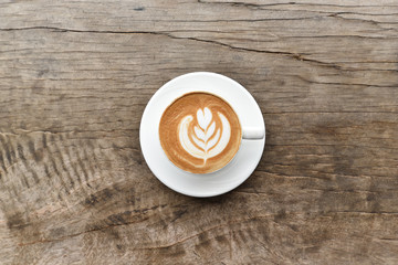 Coffee cup with latte art foam on wood table in coffee shop with copy space.Coffee is one of the most popular beverages.Improve Energy Levels and Burn Fat