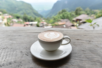 Coffee cup with latte art foam on wood table in coffee shop with copy space.Coffee is one of the most popular beverages.Improve Energy Levels and Burn Fat