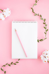 Notebook, white sheet, pencil, pant. Pink background