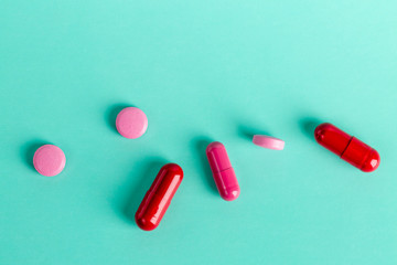 Red and pink medicinal tablets and capsules