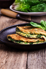 Spinach omelette in cast iron skillet, healthy vegetarian breakfast