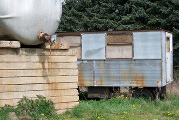 Old caravan and gas tank