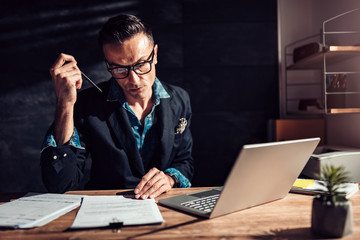 Businessman reading contract in his office