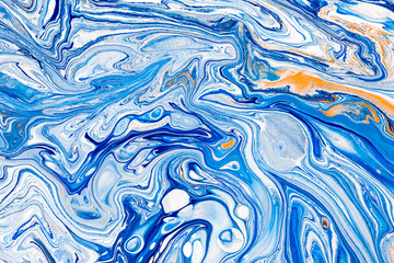 Hand painted background with mixed liquid blue, white, yellow paints. Abstract fluid acrylic painting. Applicable for packaging, invitation, textile, wallpaper, design of different surfaces