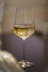 Glasses on the bar counter during a party. Transparent clean glasses in neon light on the bar prepared for drinks. 