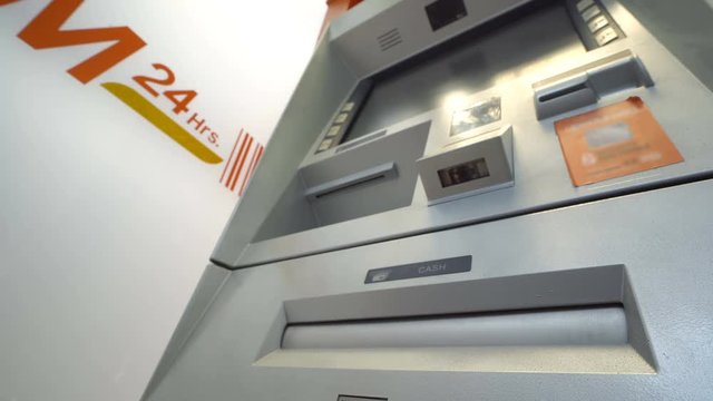Woman withdraw cash from ATM, Multi shot