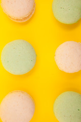Peach and green tee macaroons in rows over yellow background
