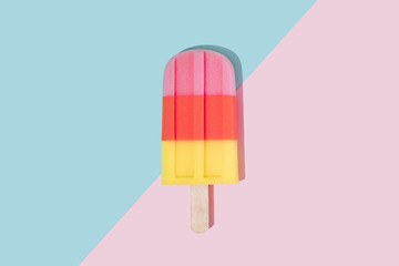 Ice cream popsicle in pastel pink on paper duotone background. Minimal summer concept. Flat lay.