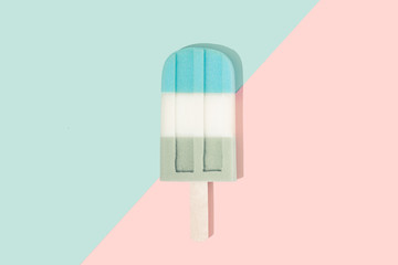 Fototapeta na wymiar Ice cream popsicle in pastel pink on paper duotone background. Minimal summer concept. Flat lay.