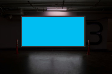 indoor car parking and empty blue billboard .Blank space for text and images.