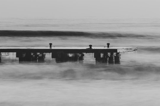 Long exposure shot of the sea and a pier in Italy