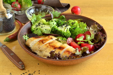 Healthy nutrition - bowl with fried chicken, broccoli, vegetables