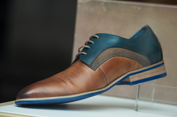 closeup of classic leather shoes for men in fashion store showroom