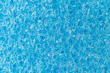 Blue porous sponge close up. Macro photo suitable as background.