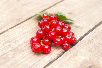 Red currant berries on the board. Summer berry background with place for text. Close-up.