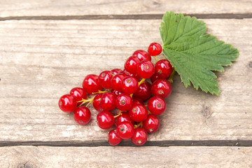 Red currant berries on the board. Summer berry background with place for text. Close-up.