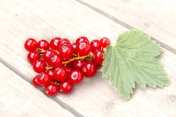 Red currant berries on the board. Summer berry background with place for text. Close-up.