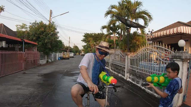 Slow motion people happy play splash water war celebration Songkran festival - local Chiang mai Thailand people in holiday traditional new year Songkran festival concept