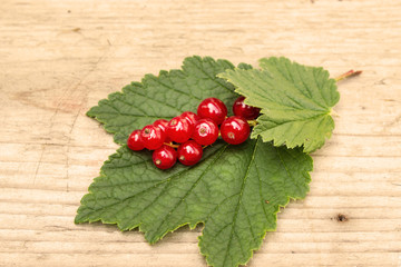 Red currant berries on the board. Summer berry background with place for text. Close-up.