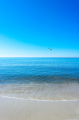 Fototapeta na wymiar Beach with white sand calm water and clear blue sky, Sylt, Germany