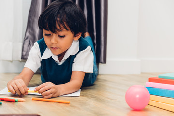 Happy child kid boy kindergarten drawing on peper teacher education