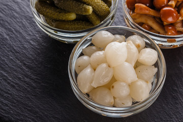 pickled vegetables on a dark stone background