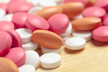 Obraz na płótnie Canvas Assorted pharmaceutical medicine pills, tablets on wooden background